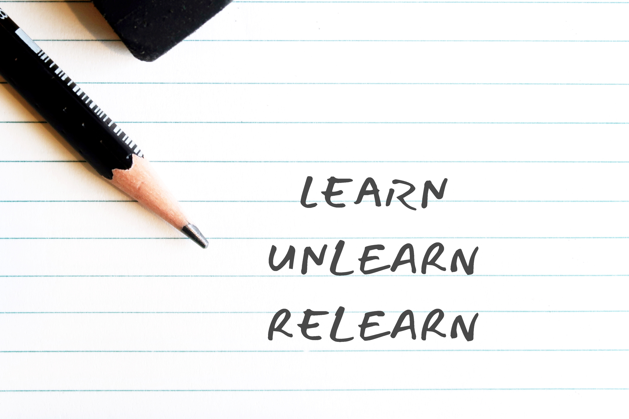 Pencil eraser on note paper background with handwritten text Learn Unlearn Relearn – concept of knowing to discard learned outdated knowledge or skills or fake information and ready to relearn new ones